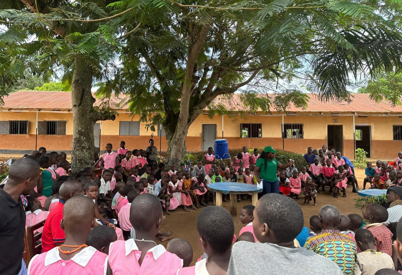 Groups of children, youth, and adults during a working meeting.